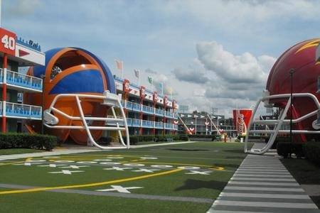 A football helmet shaped hotel with an orange and blue stripe.