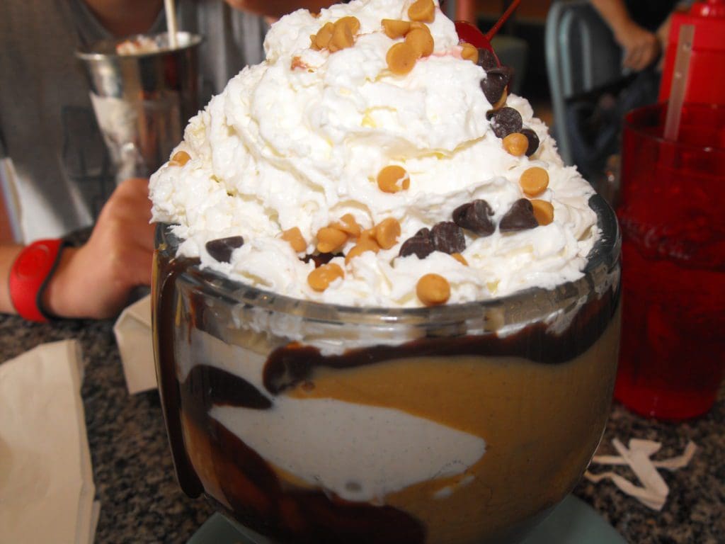 A close up of a cup with whipped cream and chocolate