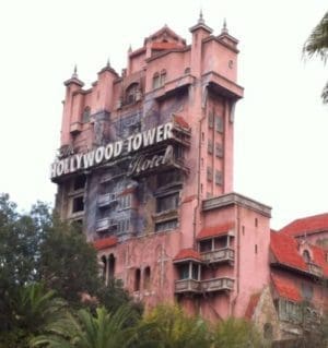 A pink building with a sign on the side of it.